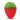 Red and green gummy candy shaped like a strawberry with textured surface on white background